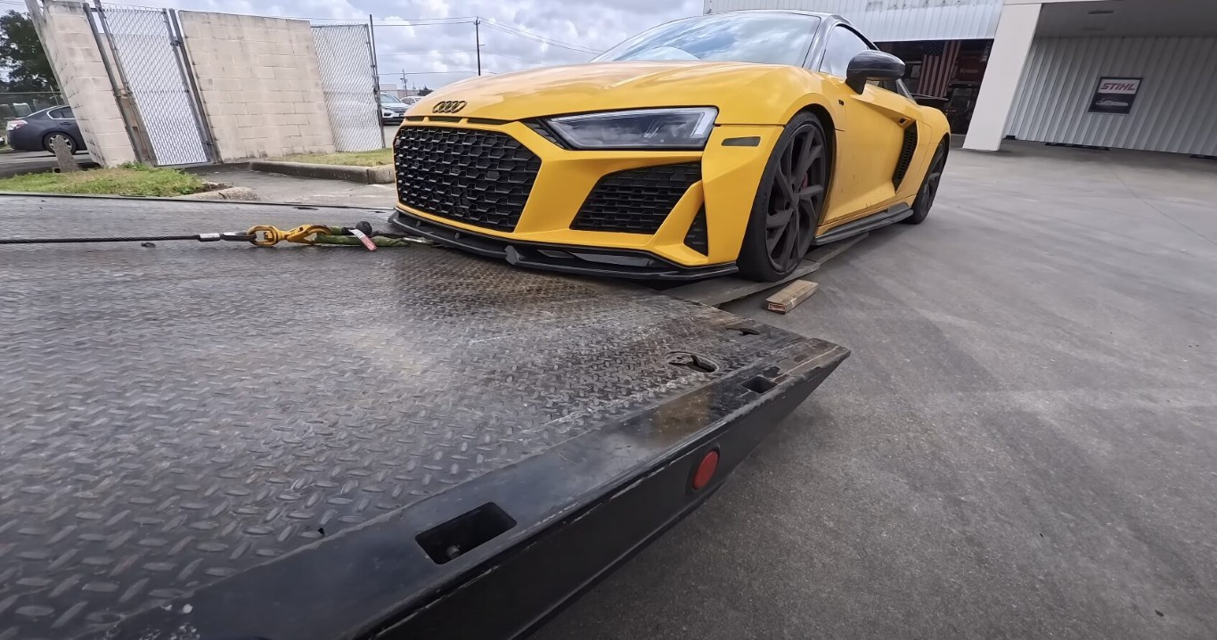 Yellow luxury sports car secured on flatbed tow truck in Gilroy, CA